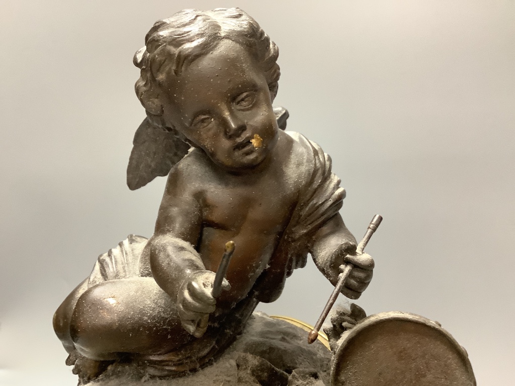 An early 20th century French spelter and slate cherub mantel clock, height 34cm